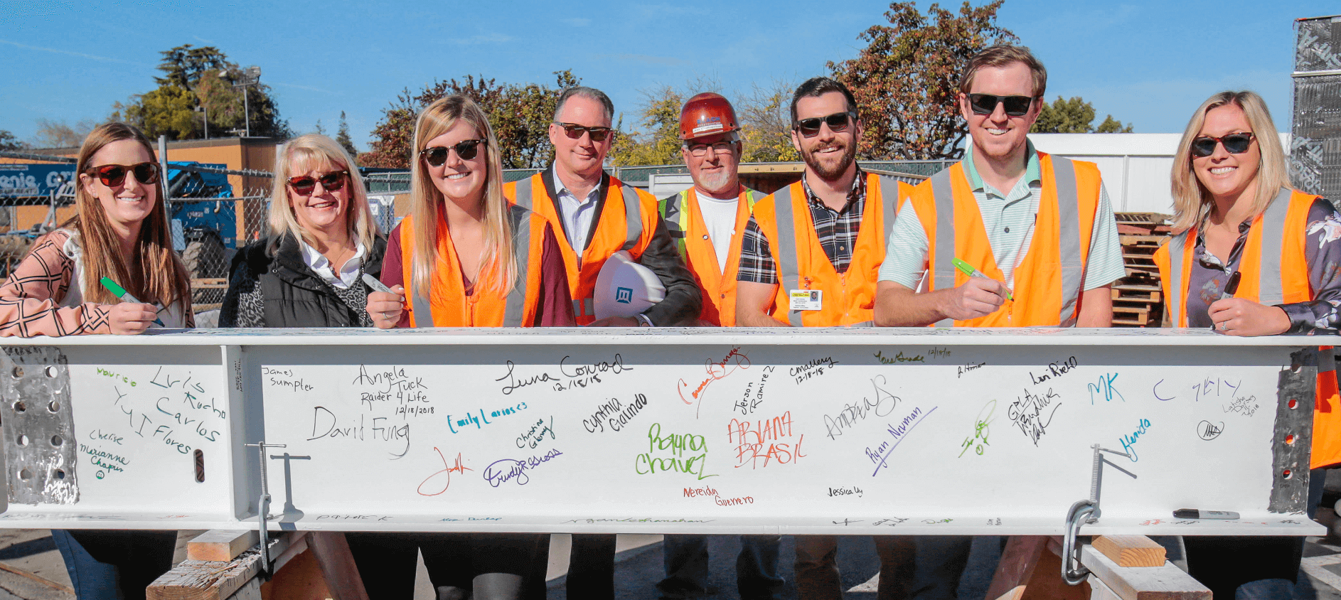 Blach construction employees beam signing